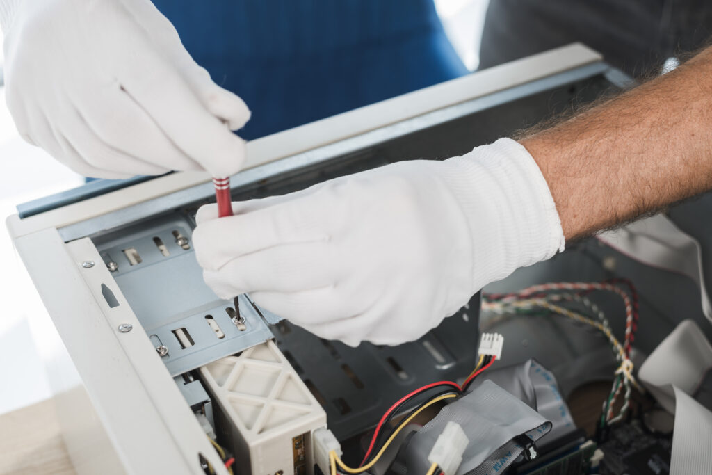 close up male technician hand wearing gloves repairing computer